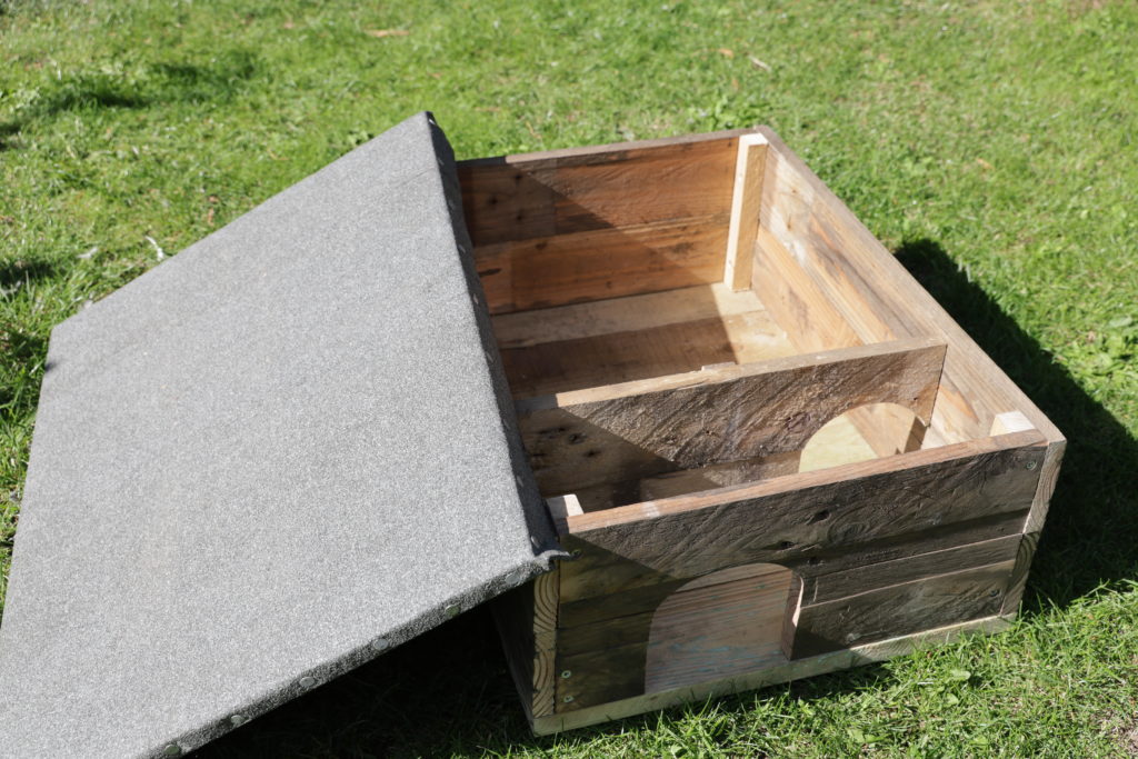 Homemade hedgehog house made from scrap pallet wood showing the inside